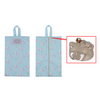 Light blue floral-patterned bag with a close-up of a silver pouch featuring a character design.
