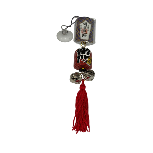 A Japanese komainu (lizard) hanging charm featuring a red bell with black kanji, three silver bells, a red tassel, and a white hanging tag with Japanese text.