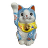 A traditional Japanese Maneki-neko ceramic lucky cat figurine with a raised paw, featuring a white and light blue body, hand-painted floral patterns, a yellow collar, and a gold bell.
