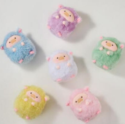 Set of colorful plush toys resembling baby bunnies on a light gray background