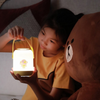 Twinkle Glory Line Friends round handle soft LED night light held by a child next to a Brown bear plush toy
