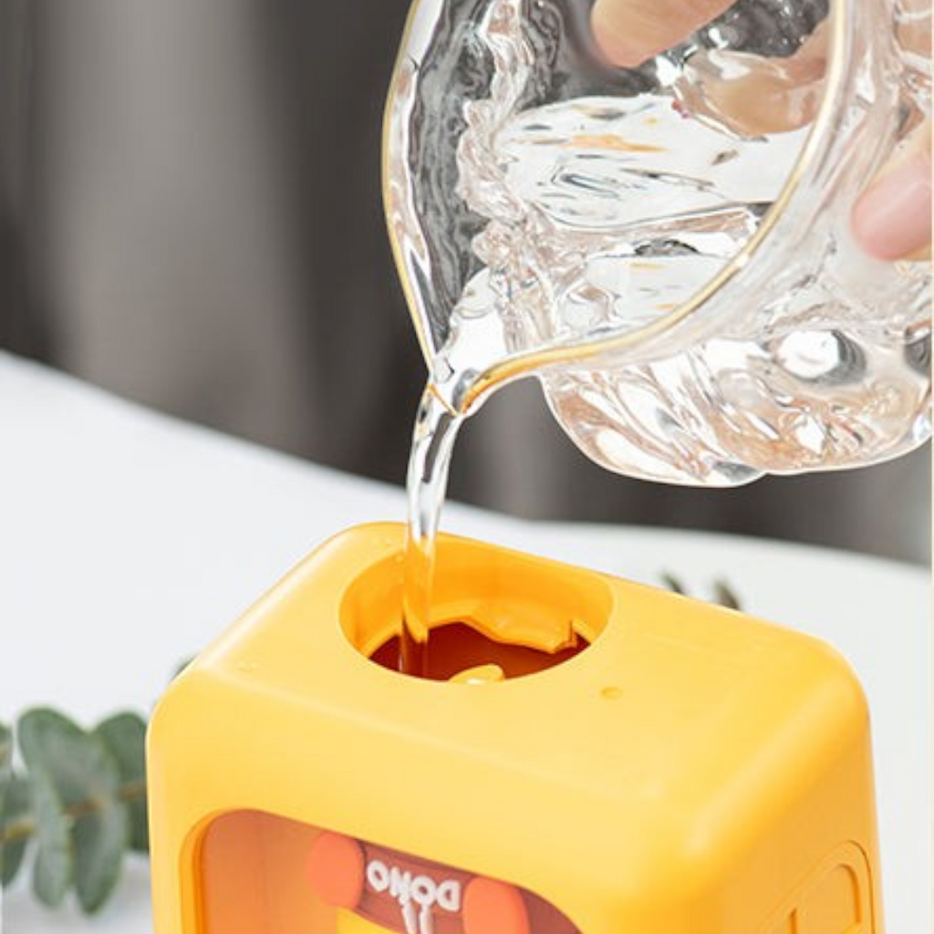 Twinkle Glory house shaped yellow and pink humidifier with cute cartoon character being filled with water