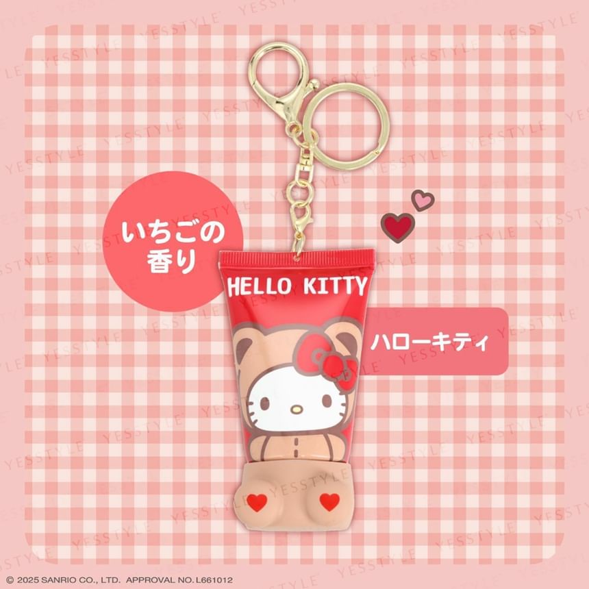 Hello Kitty-themed perfume bottle keychain on a pink checkered background