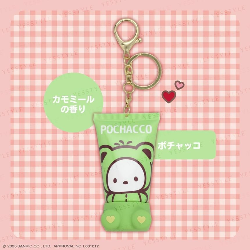 Pochacco keychain with green pouch on a pink checkered background
