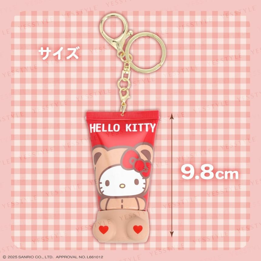 Hello Kitty keychain on a pink checkered background with size indication.