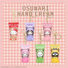 Set of cartoon-themed hand cream keychains on a pink checkered background