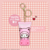 Pink keychain with cartoon character on a pink checkered background