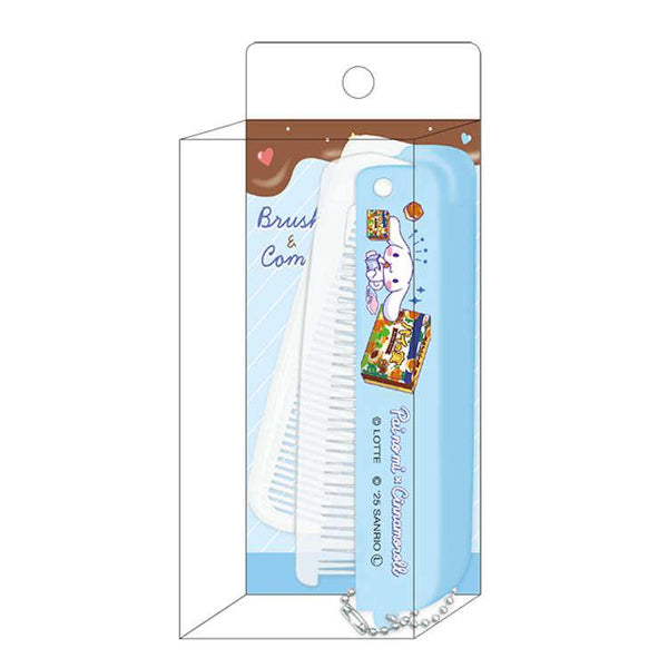 A white plastic brush with cartoon illustrations, packaged inside a clear plastic hanging display box with a blue backing card.