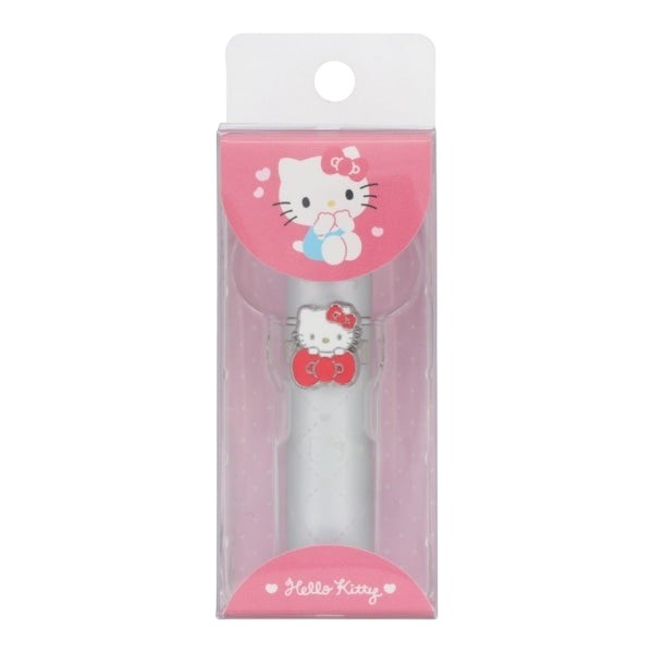 A Hello Kitty toothbrush in its original retail packaging, featuring a white toothbrush with a red bow and Hello Kitty charm, inside a pink and clear plastic box with a white hanger tab.