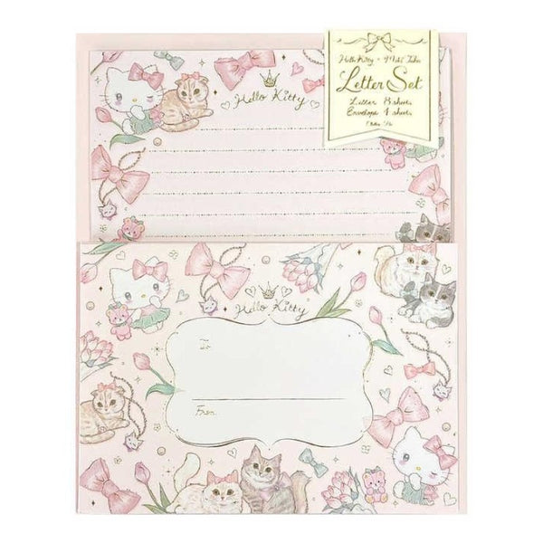 Hello Kitty letter set stationery with lined writing paper and matching decorated envelope, featuring pink bows, flowers, and illustrated cats on a white background.