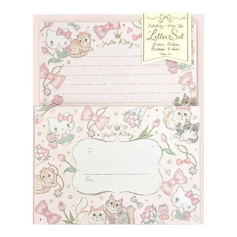 Hello Kitty letter set stationery with lined writing paper and matching decorated envelope, featuring pink bows, flowers, and illustrated cats on a white background.