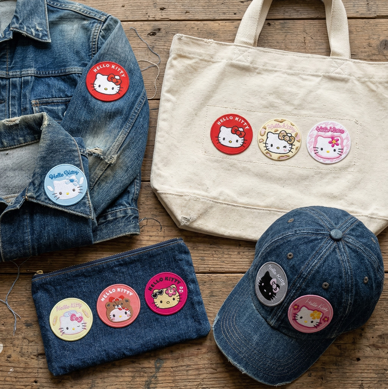 Collection of denim items with Hello Kitty buttons on a wooden surface