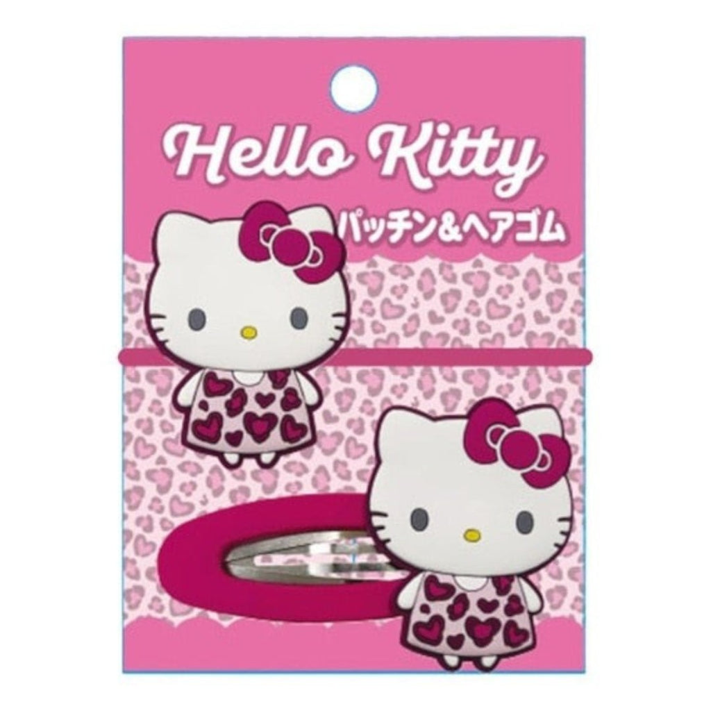 Hello Kitty hair clip in pink leopard print dress, attached to its original pink retail packaging card.