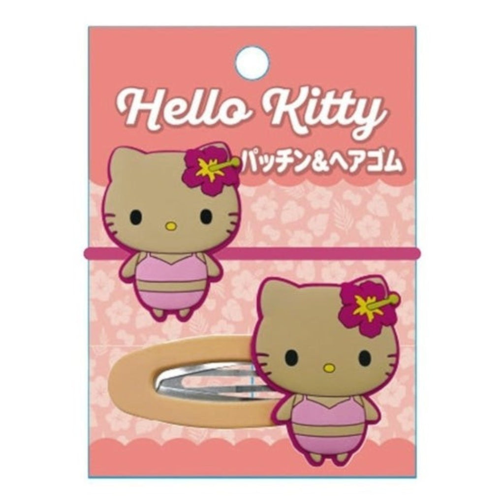 Hello Kitty hair clip in its original pink packaging card, featuring a cartoon Hello Kitty character and a visible metal spring clip.