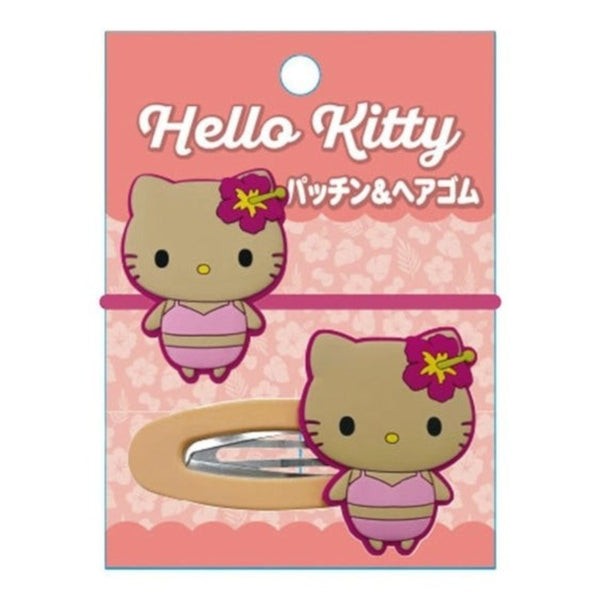 Hello Kitty hair clip in its original pink packaging card, featuring a cartoon Hello Kitty character and a visible metal spring clip.