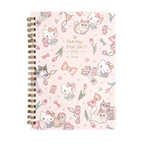 A spiral-bound notebook featuring a light pink cover decorated with Hello Kitty and Mickey Mouse illustrations, including cats, flowers, bows, and gold script text reading 'Hello Kitty Mickey Mouse & Oswald'.