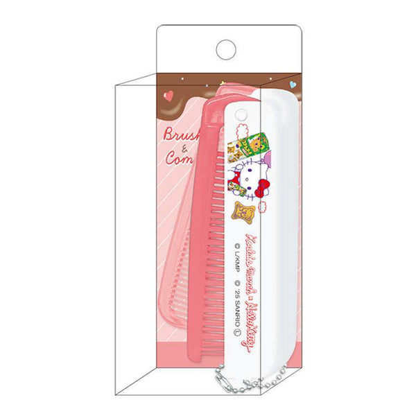 A pink and white Hello Kitty hairbrush with a matching hair comb, packaged inside a clear plastic hanging display box with a pink and brown Hello Kitty-themed insert.