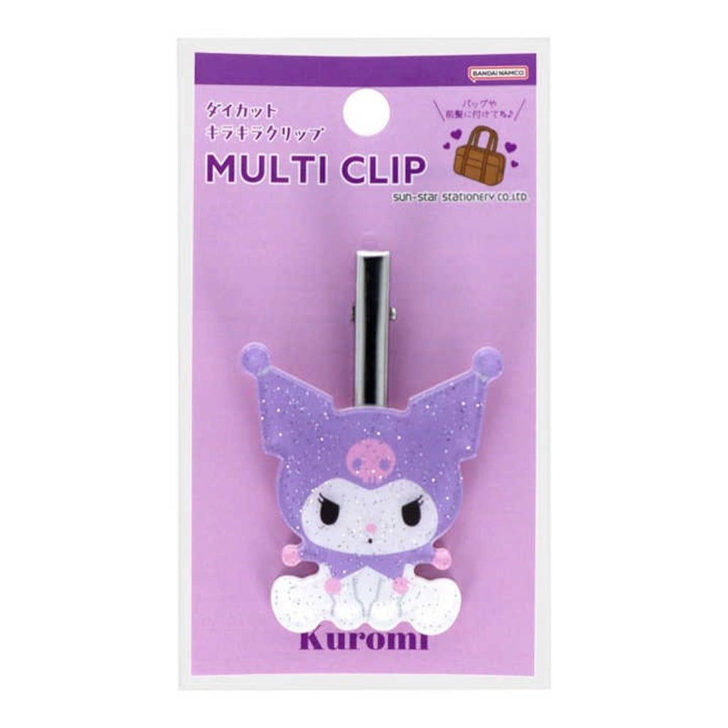 A Sanrio Kuromi multi-clip accessory in its original packaging. The clip features a purple glittery Kuromi character design with white accents and a silver metal clip mechanism, mounted on a lavender card labeled 'MULTI CLIP' with 'sanrio' branding.