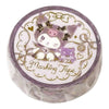 A round roll of Kuromi-themed masking tape in its clear plastic packaging, featuring a purple and white cartoon design with gold glitter accents.