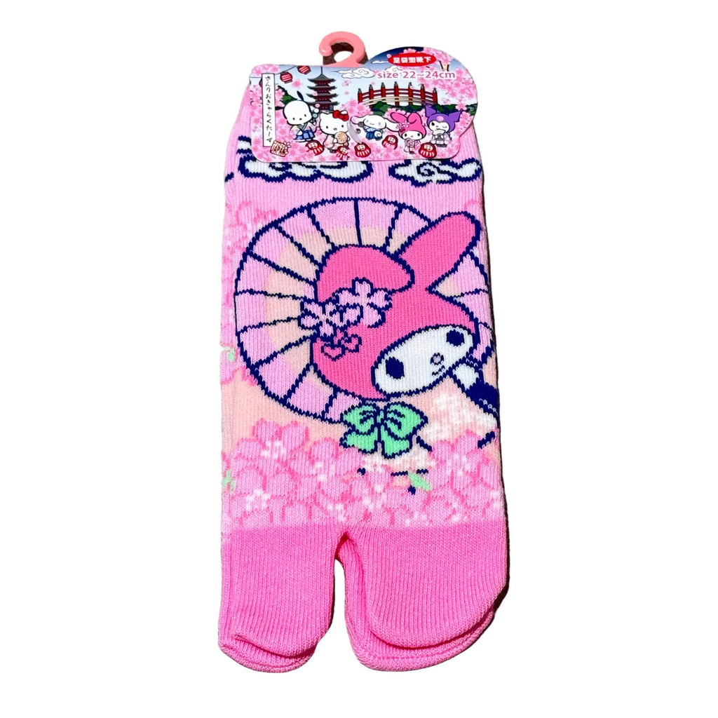 Pink tabi sock with cartoon character on a gray surface
