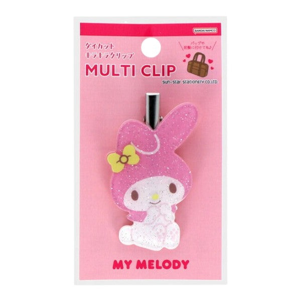 A Sanrio My Melody multi-clip hair accessory in its original pink retail packaging. The clip features a glittery pink bunny head with a yellow bow and a white body, attached to a silver metal clip.