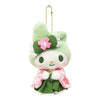 A small plush character keychain or bag charm on a white background. The character has a pale green bunny hat with a pink flower and green bow, wearing a pink and green kimono-style outfit, and is attached to a gold ball chain.
