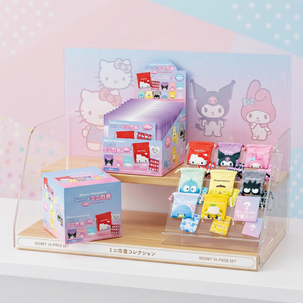 Display of small figurines and packaging with cartoon characters on a light pink background