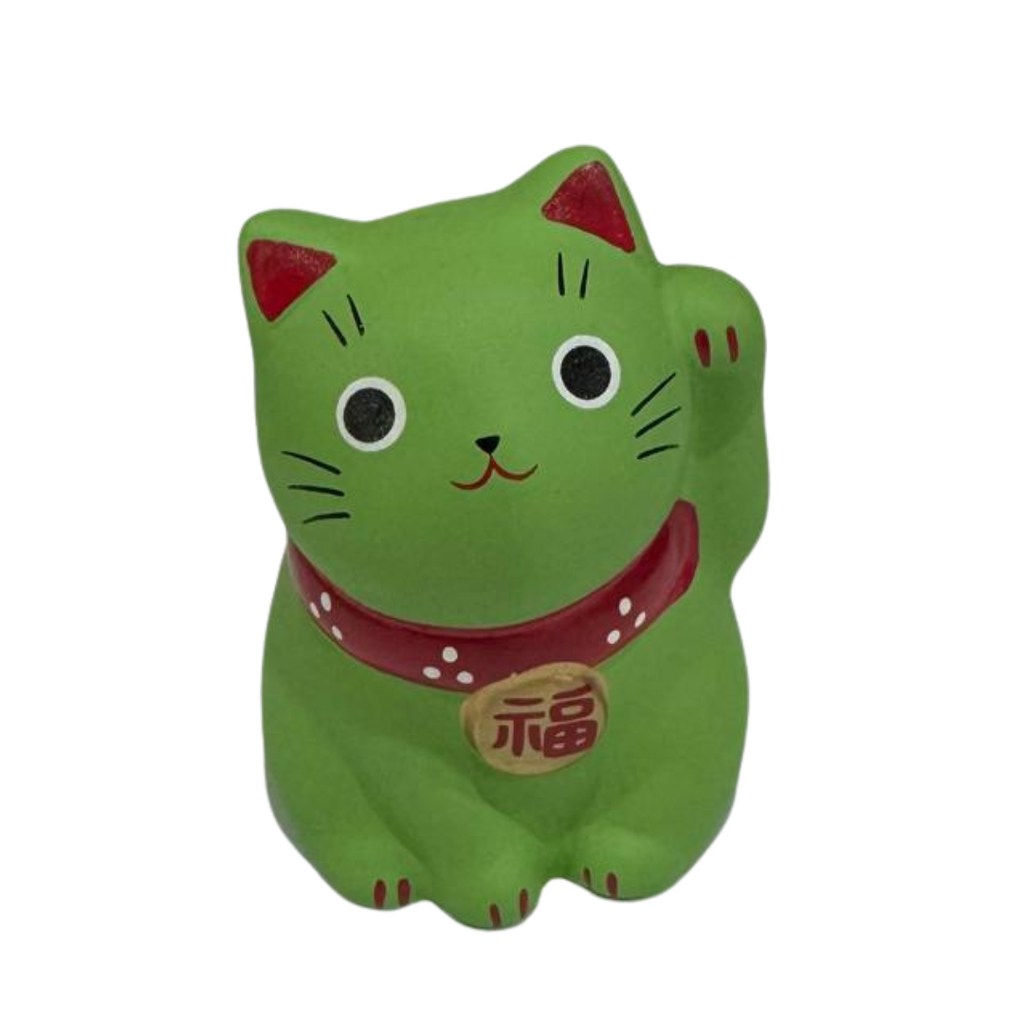 A green maneki-neko lucky cat figurine with a raised paw, featuring red inner ears, a red collar with white dots, and a gold medallion with a red Japanese character, set against a plain white background.