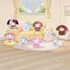 Twinkle Glory Sanrio Hello Kitty Puppy Party collection featuring various fluffy plush bag charms on a living room sofa