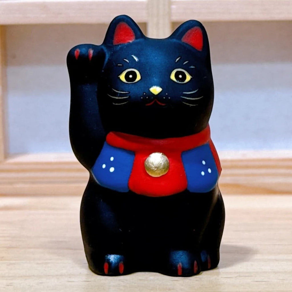 Twinkle Glory Yakushigama black Maneki-Neko porcelain lucky cat figurine with red and blue collar