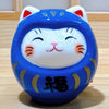 Twinkle Glory hand-painted blue porcelain Daruma lucky cat figurine with a smiling face and gold accents