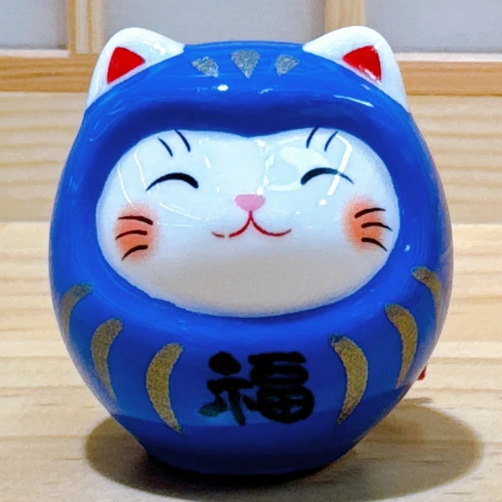 Twinkle Glory hand-painted blue porcelain Daruma lucky cat figurine with a smiling face and gold accents