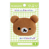 Twinkle Glory San-X Chairoikoguma plush badge featuring a brown bear face with a wink and lick expression