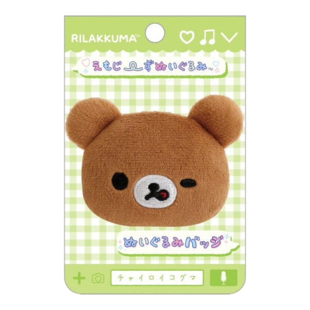 Twinkle Glory San-X Chairoikoguma plush badge featuring a brown bear face with a wink and lick expression