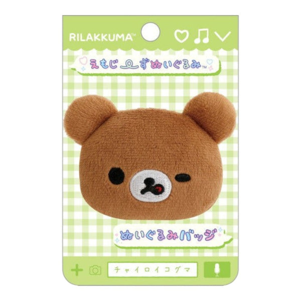 Twinkle Glory San-X Chairoikoguma plush badge featuring a brown bear face with a wink and lick expression