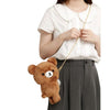 Twinkle Glory San-X Chairoikoguma plush bear pochette with gold chain strap worn by a person in a white blouse