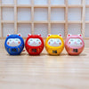 Twinkle Glory set of four colorful hand-painted porcelain Daruma lucky cat mascots on a wooden surface
