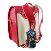 Twinkle Glory Demon Slayer PVC polyester key case with retractable reel attached to a red and cream school backpack
