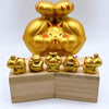 Twinkle Glory gold muscle lucky cat porcelain figurines in various poses on wooden blocks