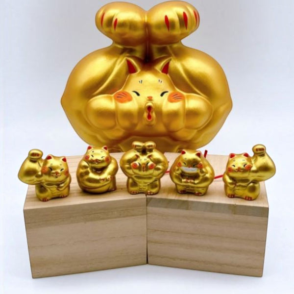 Twinkle Glory gold muscle lucky cat porcelain figurines in various poses on wooden blocks