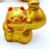 Twinkle Glory hand-painted gold porcelain lucky cat figurine with a muscular arm for prosperity and good fortune.
