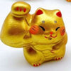 Twinkle Glory gold porcelain lucky cat figurine with a muscular arm, hand-painted with a cheerful expression.