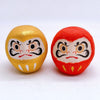 Twinkle Glory Japanese paper Daruma heads in gold and red with traditional hand-painted facial features