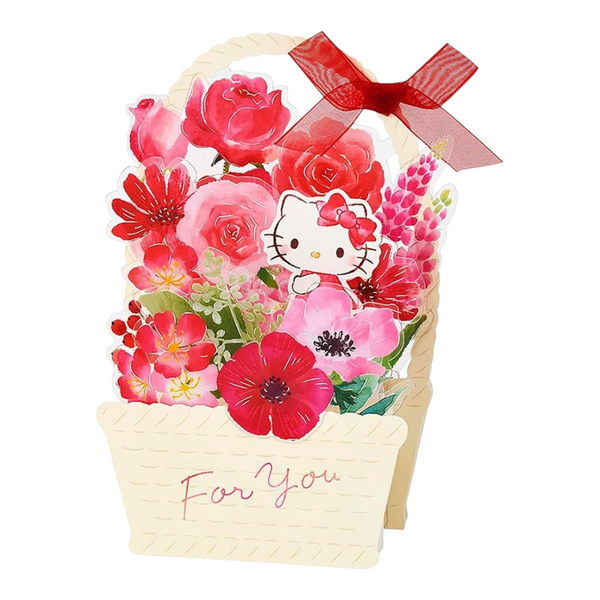 Twinkle Glory Sanrio Hello Kitty greeting card featuring a paper basket filled with red flowers and a red ribbon bow
