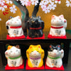 Twinkle Glory Japanese Six Blessings Maneki Neko ceramic cat figurines in various colors on red felt cushions