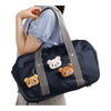 Twinkle Glory San-X Kiiroitori plush badge with grumpy face attached to a navy blue shoulder bag