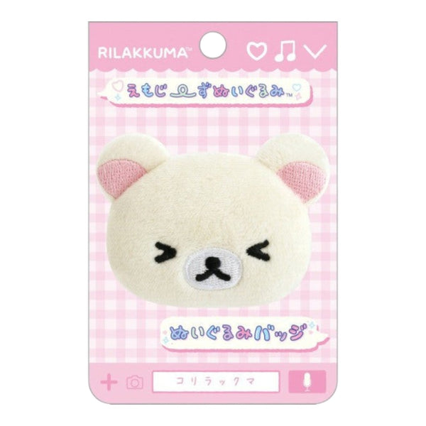 Twinkle Glory San-X Korilakkuma plush badge featuring a white bear with squeezed eyes on a pink gingham backing card