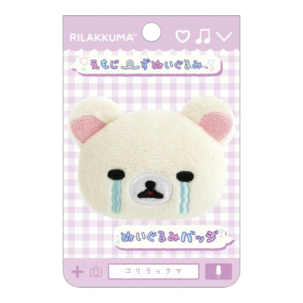 Twinkle Glory San-X Korilakkuma plush badge featuring a white bear face with blue crying tears on a display card