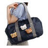 Twinkle Glory San-X Korilakkuma and Rilakkuma plush badges attached to a navy blue school bag