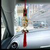 Twinkle Glory Japanese lucky cat car charm with a waving paw, gold bell, and red tassel hanging from a rearview mirror